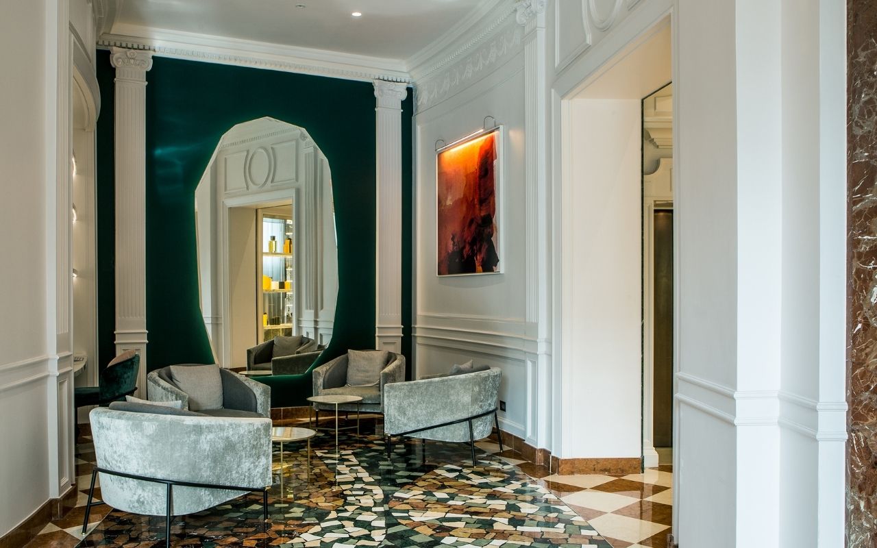 Decoration of a lounge with a large mirror in the Hotel Sofitel Rome Villa Borghese designed by the French interior design studio Jean-Philippe Nuel